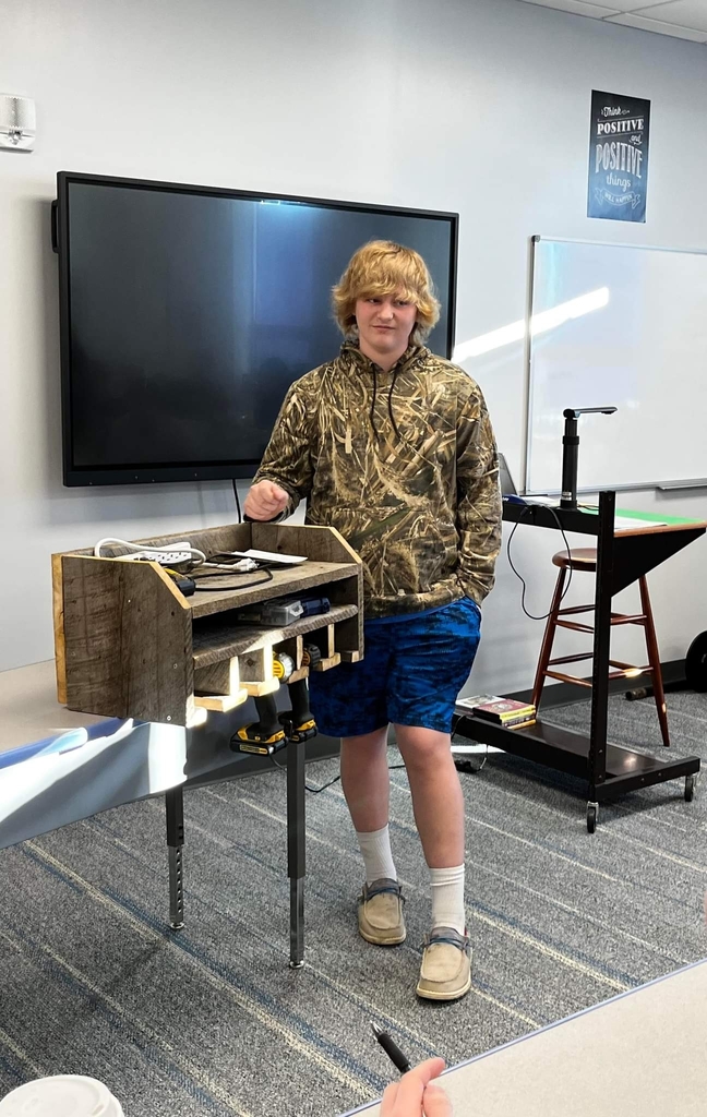 student demonstrating his invention