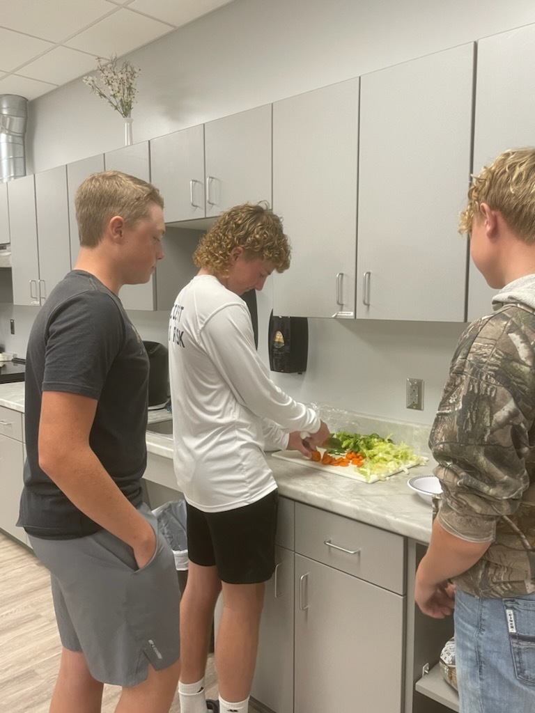 Foods class chopping vegetables