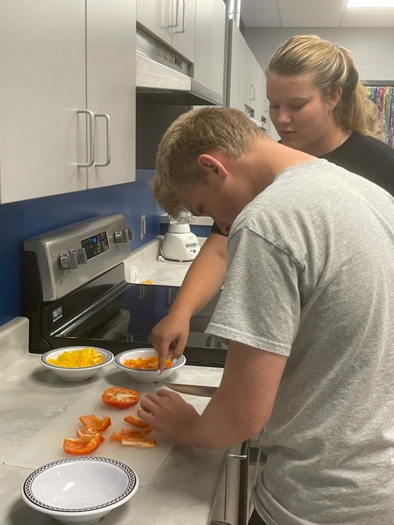 Foods class chopping vegetables